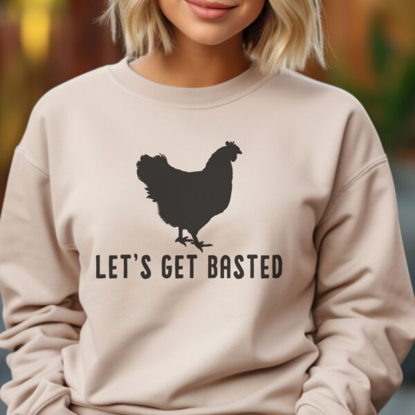 Sand color shirt with a black silhouette of a rooster and words that say Let's get Basted